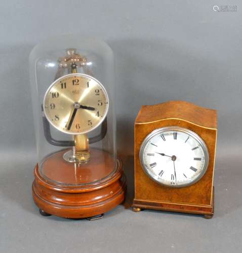 A Bulle electric Clock with Glass Dome and turned wooden stand together with a walnut cased mantle