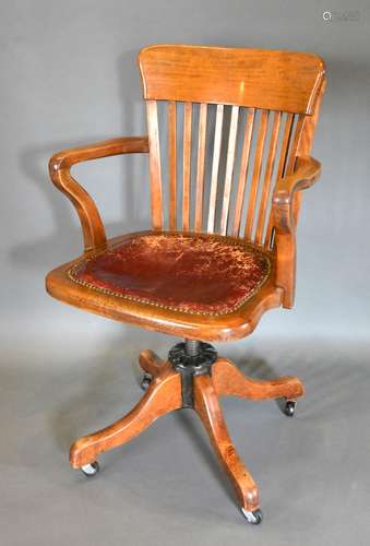 A Victorian Mahogany Revolving Office Armchair with outswept legs