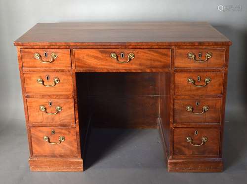 A 19th Century Mahogany Twin Pedestal Desk with an arrangement of nine drawers with brass handles,