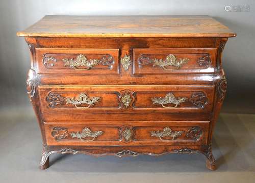 An 18th Century French Oak Commode, the moulded top above two short and two long drawers with