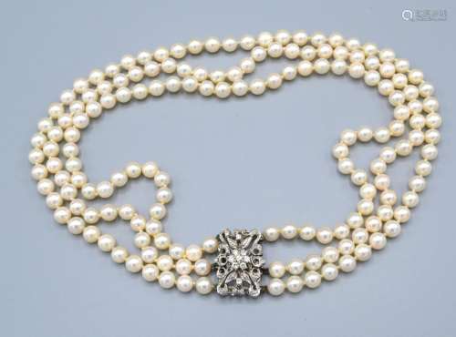 A Triple Row Cultured Pearl Necklace, the 18ct. white gold clasp with a central diamond cluster