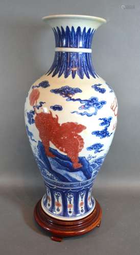 A Chinese Porcelain Oviform Vase decorated with iron red Fu dogs with underglaze blue six