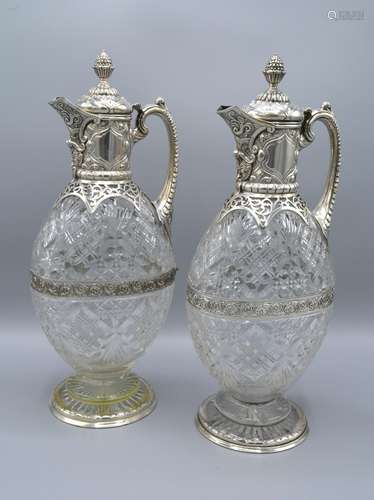 A Pair of Victorian Silver and Cut Glass Claret Jugs each with a pineapple finial and shaped