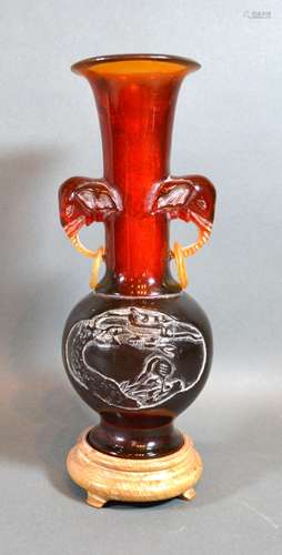 An Early 20th Century Chinese Amber Resin Vase with hardwood stand, 24 cms tall