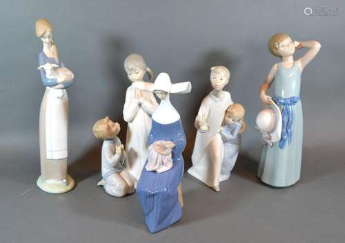 A Lladro Group 'Boy and Girl Holding a Candle' together with four other Lladro figures and a