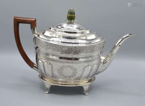 A George III Silver Teapot of Oval Form with an engraved band together with a matching teapot