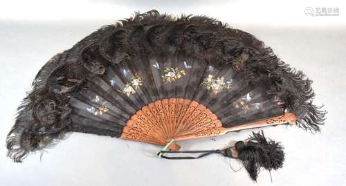 An Early 19th Century Carved Wooden Lace and Feather Fan with carved and pierced sticks and guards