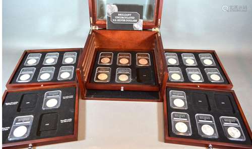 A Collection of 23 US Silver Dollars within collectors' box of five drawers