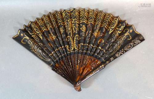 A Tortoiseshell and Black Gauze Fan with gilded decorated tortoiseshell sticks and guards and