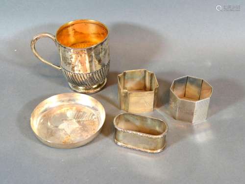 A London Silver Christening Mug of half lobed form together with three silver napkin rings and a