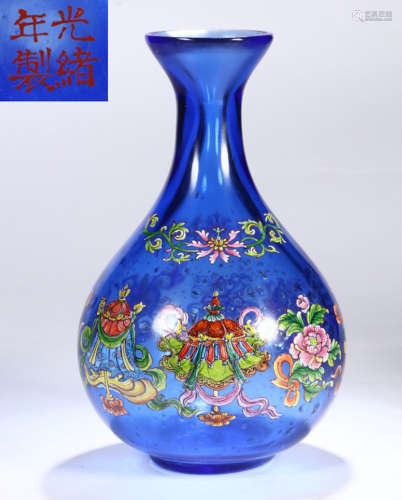 A BLUE GLASS VASE WITH FLOWER PATTERN