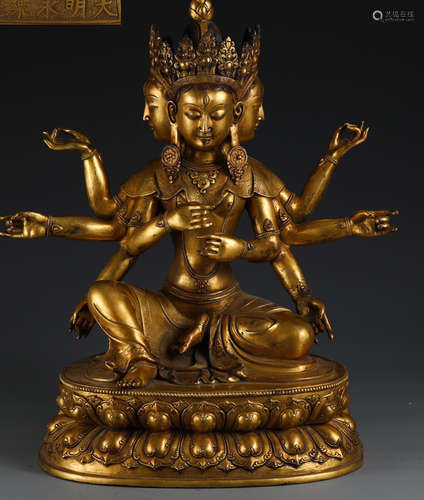 A GILT BRONZE BUDDHA STATUE WITH EIGHT ARMS