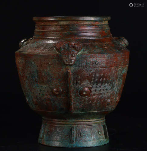 A COPPER CONTAINER WITH BEAST ERAS