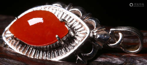 A RED JADEITE AND SILVER PENDANT