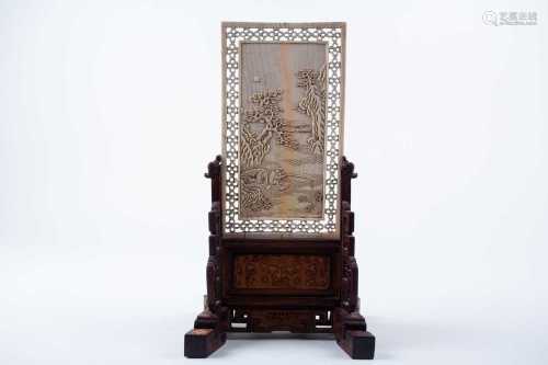 A Chinese carved ivory table screen, 17th/18th century, of rectangular form, carved in relief with a