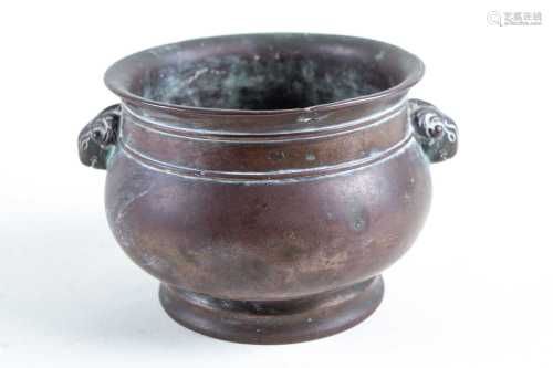 A Chinese bronze censer, Qing, 19th century, the everted rim above string bands, with rams mask