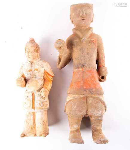 Two Chinese pottery tomb guardians, Tang dynasty, one modelled with a fierce expression, dressed