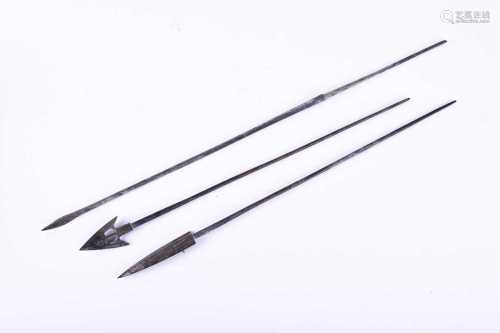 Three Chinese bronze cross bow bolts, Warring States, each upon a long plain shaft, 27.5cm, 29cm &