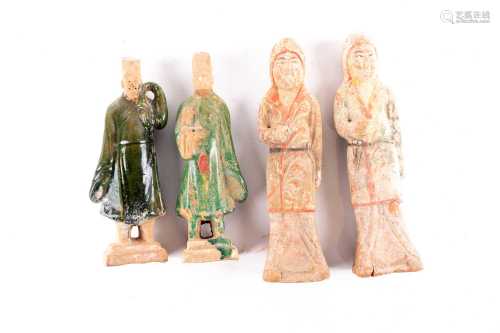 Two pairs of Chinese pottery tomb figures, Tang dynasty, comprising two porters with green glazed