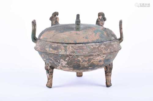 Warring States Period, 475-221 BC. A squat bronze Ding vessel with three mask legs, median ridge,