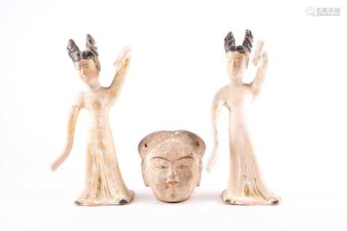 A pair of Chinese pottery dancing maidens, Tang dynasty, with their black painted hair tied in