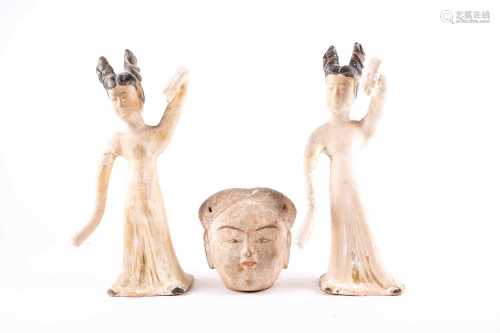 A pair of Chinese pottery dancing maidens, Tang dynasty, with their black painted hair tied in