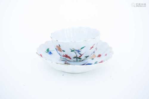 A Chinese fluted tea bowl and saucer, circa 1720, enamelled and gilt in a strong palette, with