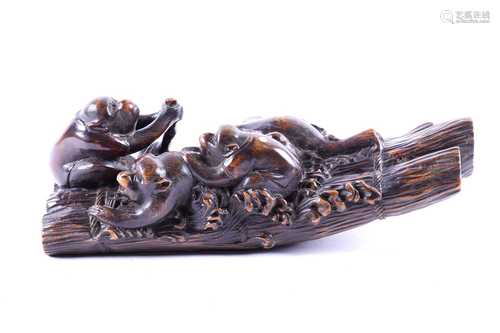 A Japanese carved wood okimono of five apes on a raft, signed Eisu, Meiji period, well carved with