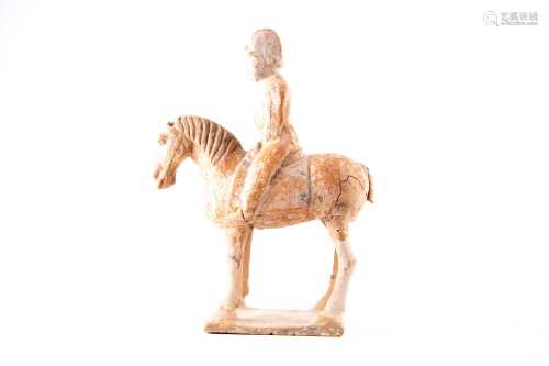 A Chinese pottery figure of a horse and rider, Tang dynasty, possibly a military figure wearing a