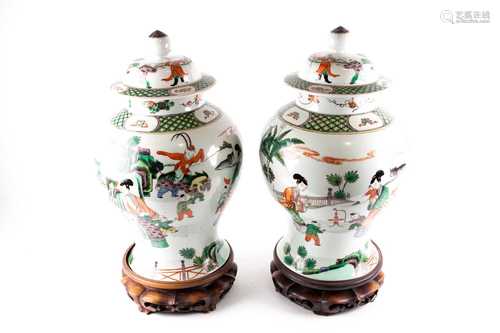 A pair of Chinese Famille Verte vases and covers, early 20th century, the covers with boys in a