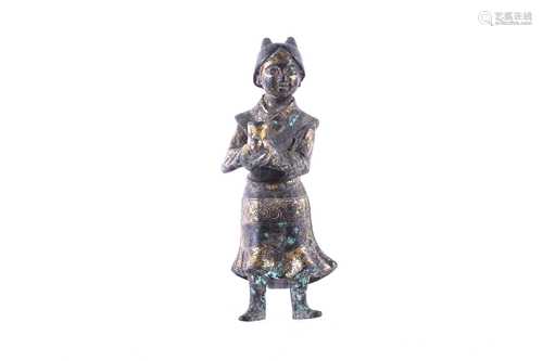 A Chinese parcel gilt bronze figure of a court attendant, probably Ming Dynasty, her hair in the