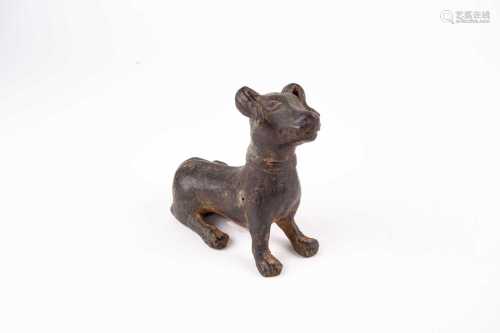 A Chinese bronze dog, probably Ming dynasty, in an alert pose, a collar around its neck, its tail