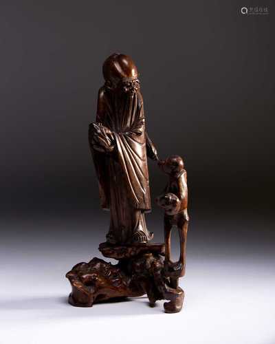 A Chinese carved wood figure of Shoulao and a Monkey, Qing, 18th century, the deity holding a