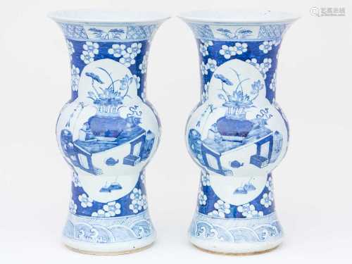 A pair of Chinese blue & white Gu form vases, 19th century, decorated with quatrelobed panels of