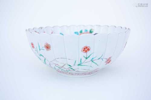 An Arita Kakiemon style fluted bowl, circa 1690, chrysanthemum moulded and boldy enamelled and