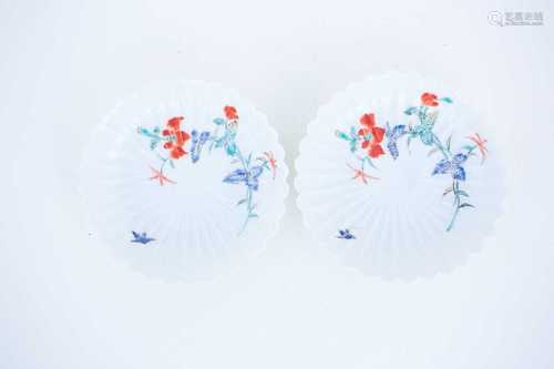 A pair of fluted Kakiemon saucers, circa 1770, each enamelled with a spray of flowers and a small