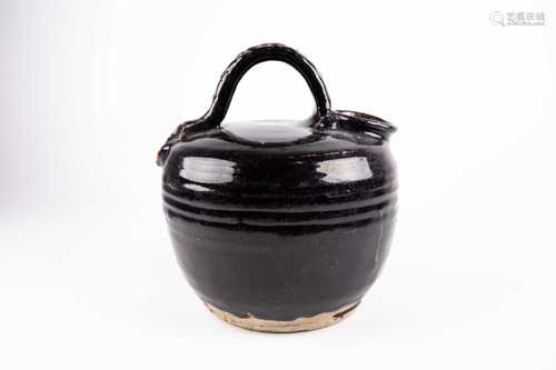 A Chinese Henan style stoneware ewer, with basket weave style strap handle and circular mouth