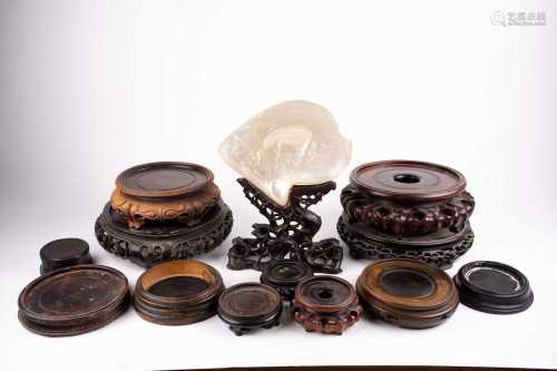 A collection of twelve Chinese carved wood vase stands, principally 19th century, 8cm - 24cm