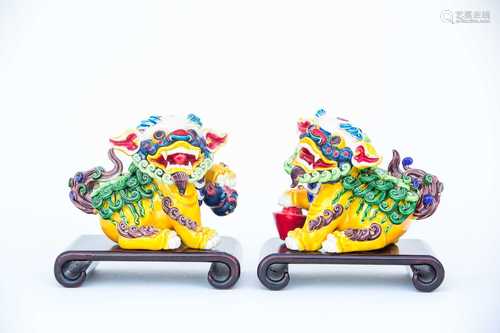 A pair of Chinese dogs of Fo, 20th century, each painted in bright enamels, one with a double