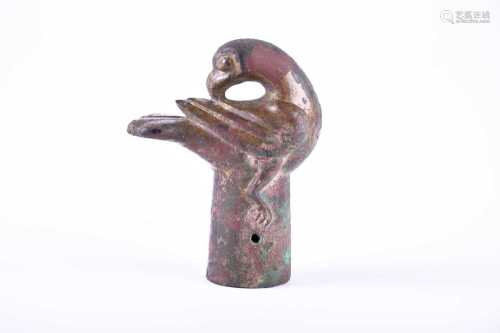 A Chinese bronze staff finial in the form of a preening hawk, Warring States or Western Han Dynasty,