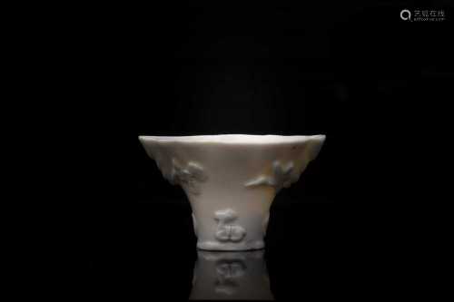 A Chinese blanc de Chine cup, 18th/19th century, modelled as a Rhinoceros horn libation cup, with
