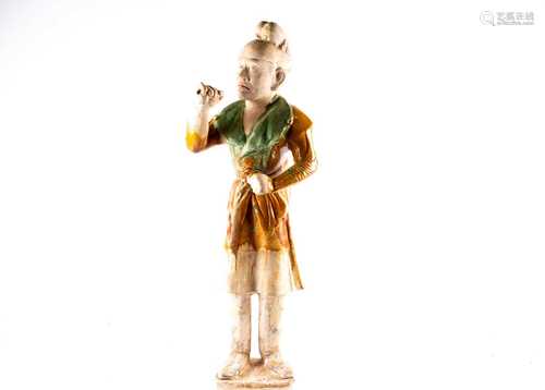 A Chinese Sancai glazed pottery figure of a Western groom, Tang dynasty, modelled standing, his face