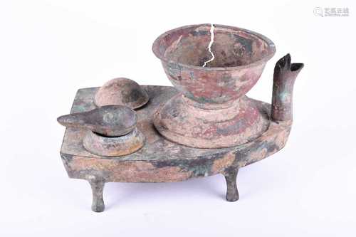 A Chinese boat shape bronze stove, Tzau, Han Dynasty (206BC - 220AD), with two egg poachers, a spoon