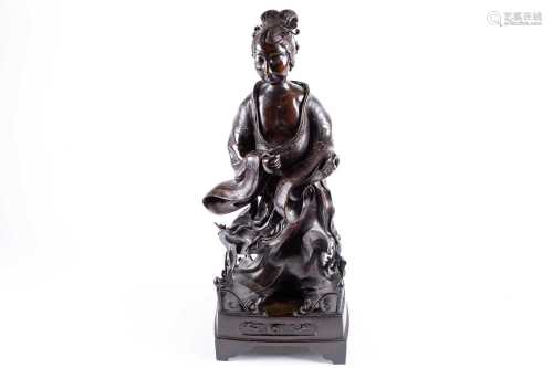 A Japanese bronze figure of a lady, Edo, 18th century, her hair combed back into a scroll held by an