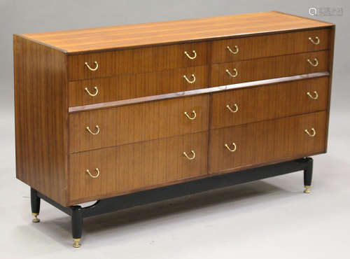 A G-Plan E. Gomme teak sideboard, the eight drawers with applied gilt brass handles, on ebonized