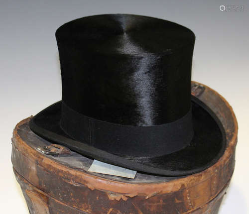 A black moleskin top hat by Henry Heath Ltd, head circumference 55cm, together with a brown