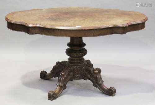 A 19th century mahogany centre table, the shaped top raised on a turned column and scroll legs,