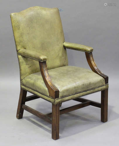 A 20th century George III style mahogany framed library armchair, upholstered in pale green leather,