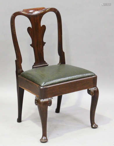 A George II mahogany side chair, the shaped splat back above a dark green leather seat, on carved