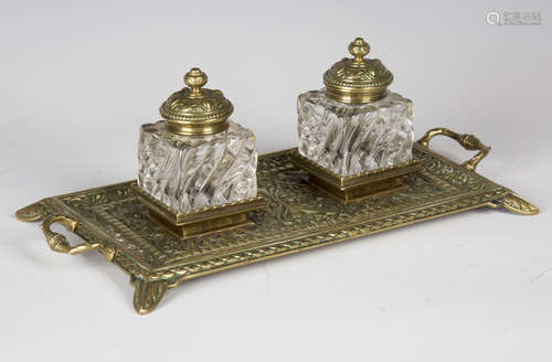 A late Victorian cast brass inkstand by William Tonks & Sons, fitted with a pair of reeded glass